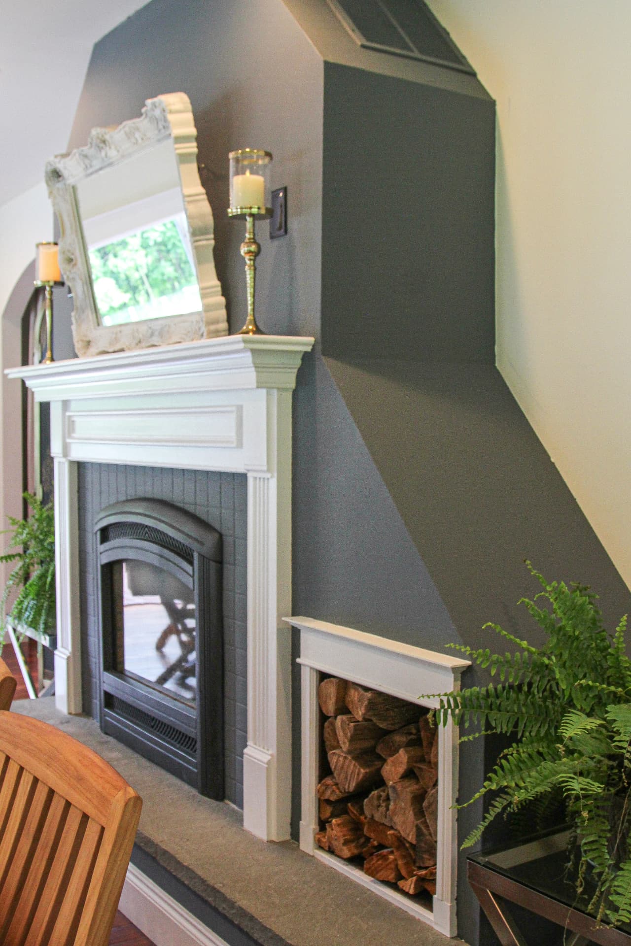 Fireplace corner with firewood nook and ferns
