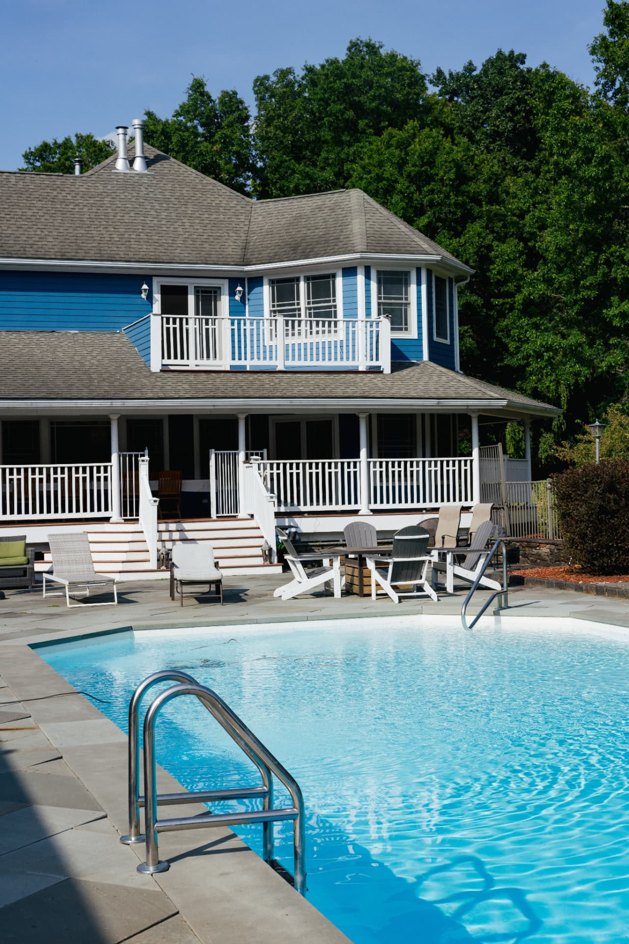 Heated pool and bluestone patio beside the house