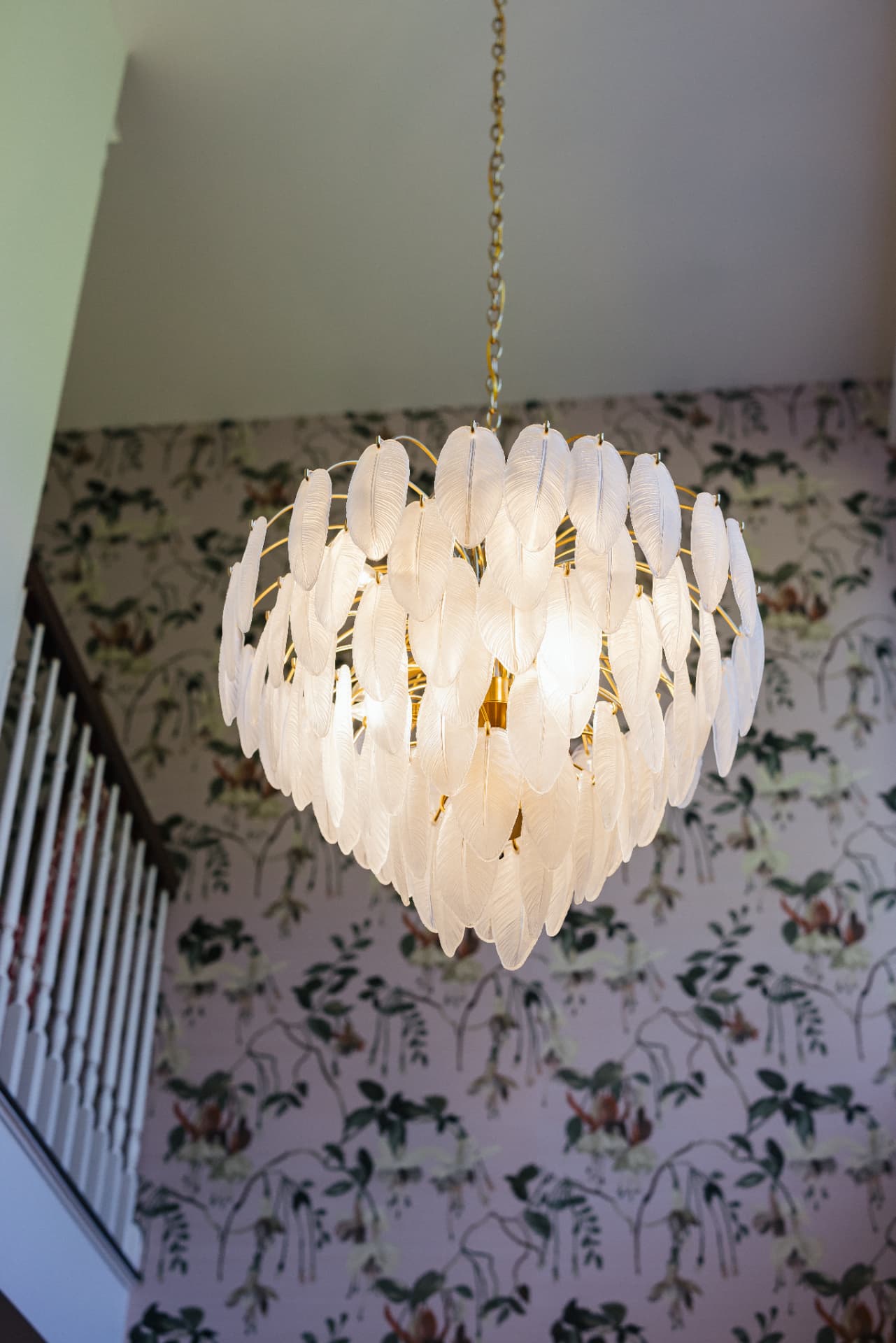 Feathered glass chandelier above the staircase