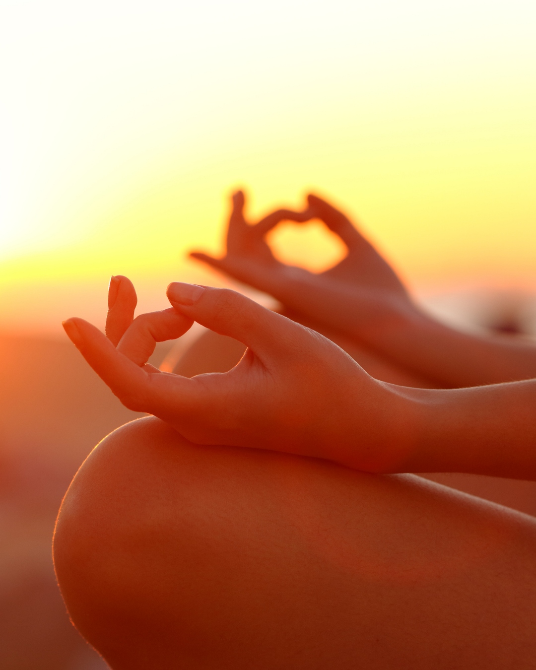 Meditation and mindfulness — hands in mudra pose at golden hour, wellness retreat at Thee Wild Lux